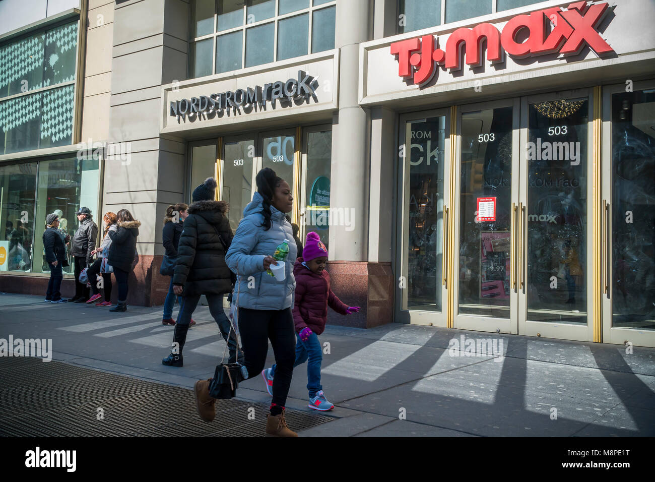 Off-price retailers Nordstrom Rack and TJ Maxx share space in a building in Downtown Brooklyn in New York on Sunday, March 18, 2018, 2018. The area has been for years a middle and lower economic shopping strip but because of increased development in the area, notably hi-rise luxury apartment buildings, chain stores and high-end retailers are moving in. Rents are rising and the smaller mom and pop stores, as well as regional chains are being forced out.  (Â© Richard B. Levine) Stock Photo