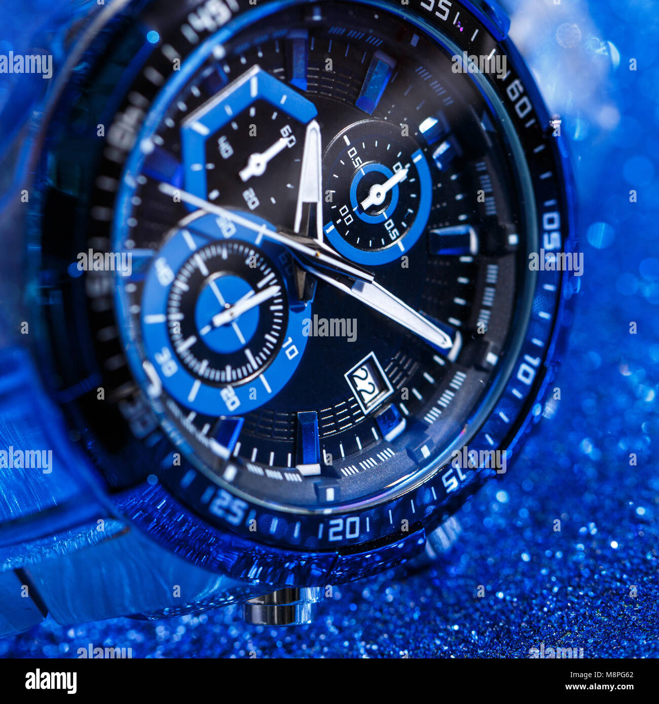 Wrist watch in close up on a blue abstract background Stock Photo Alamy