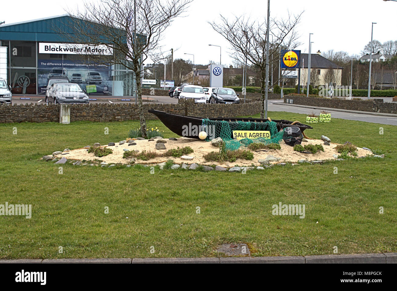 boat sale agreed as a roadside decoration of a roundabout in skibbereen, west cork, ireland Stock Photo