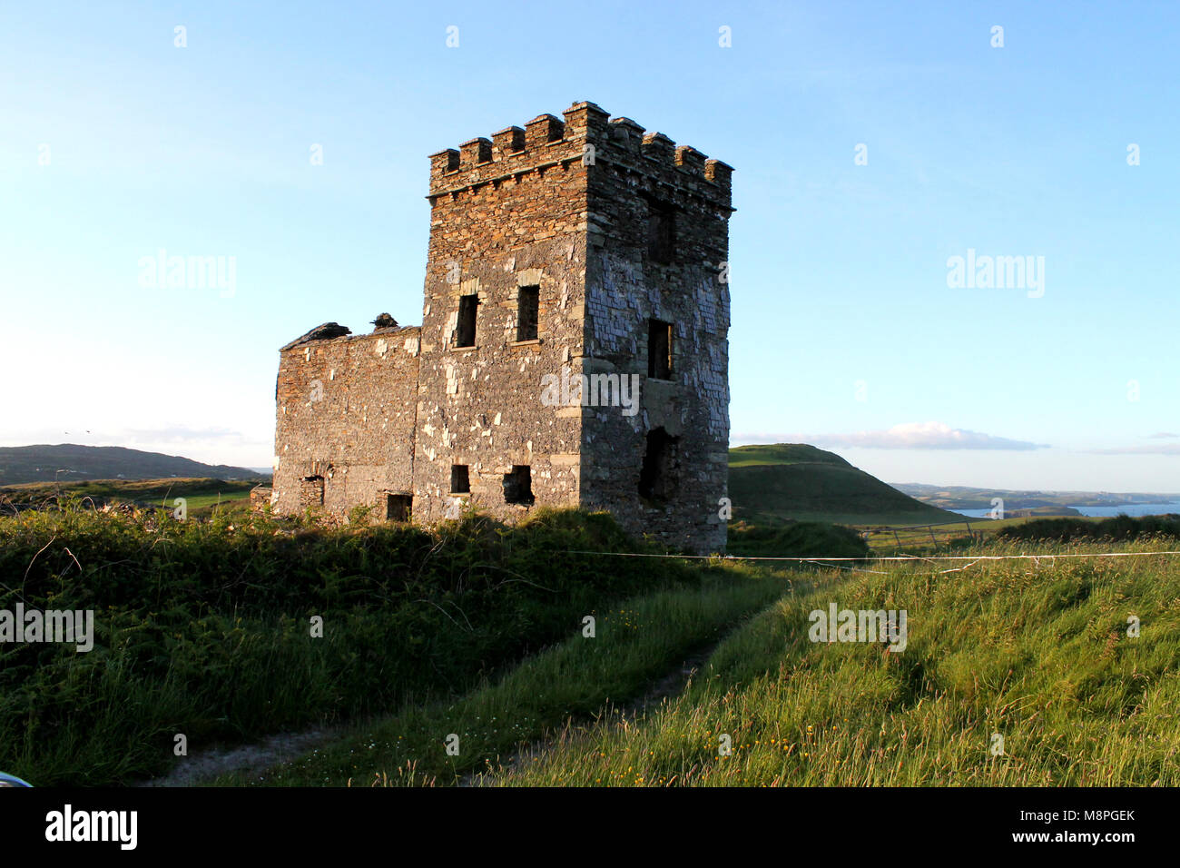 napoleonic watch tower on the skyline at sunset, west cork, ireland, overlooking the coastline and surrounding countryside. Stock Photo