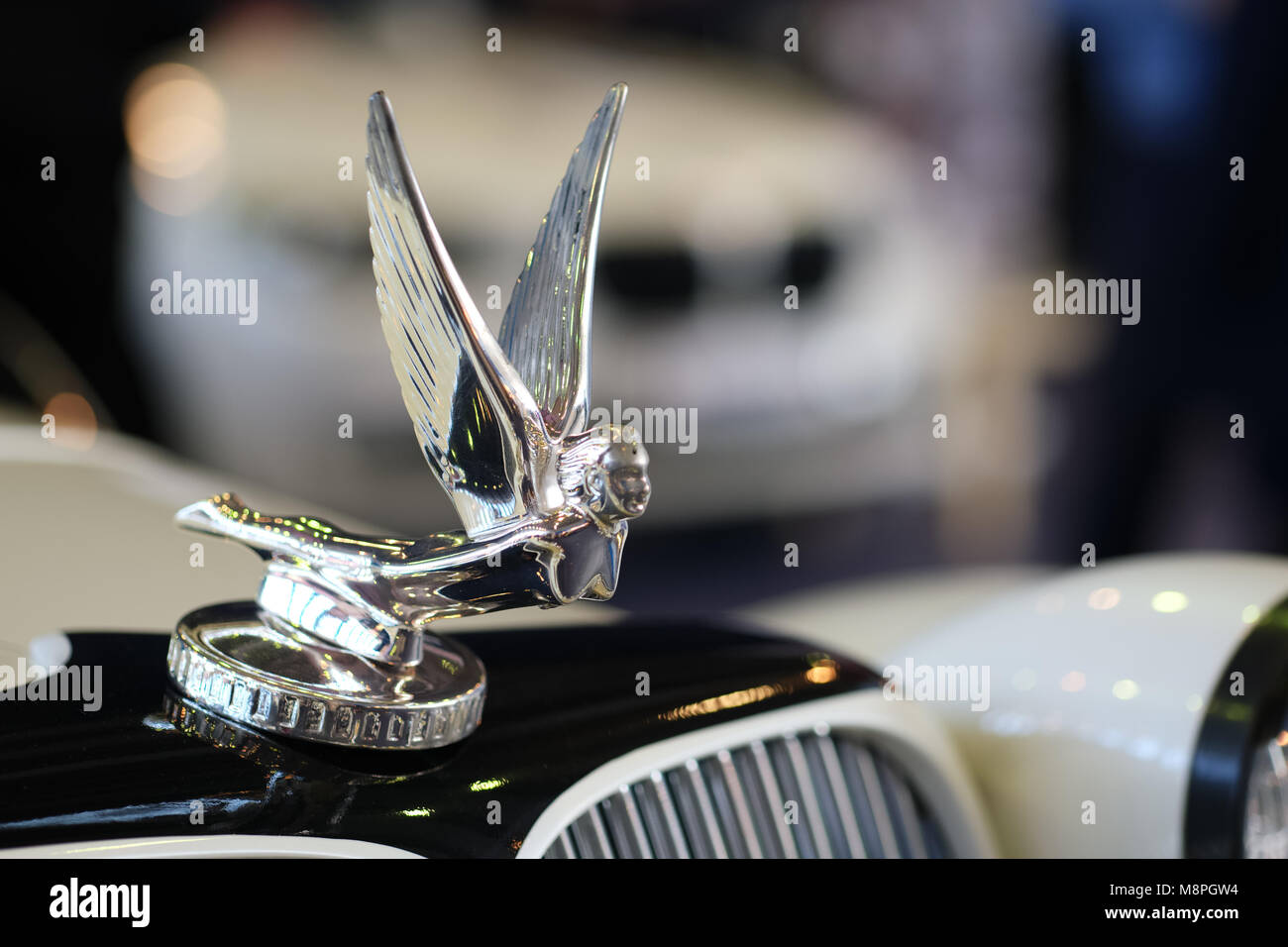 Figure of flying angel on thetop of car hood. Objects at vintage car show Stock Photo