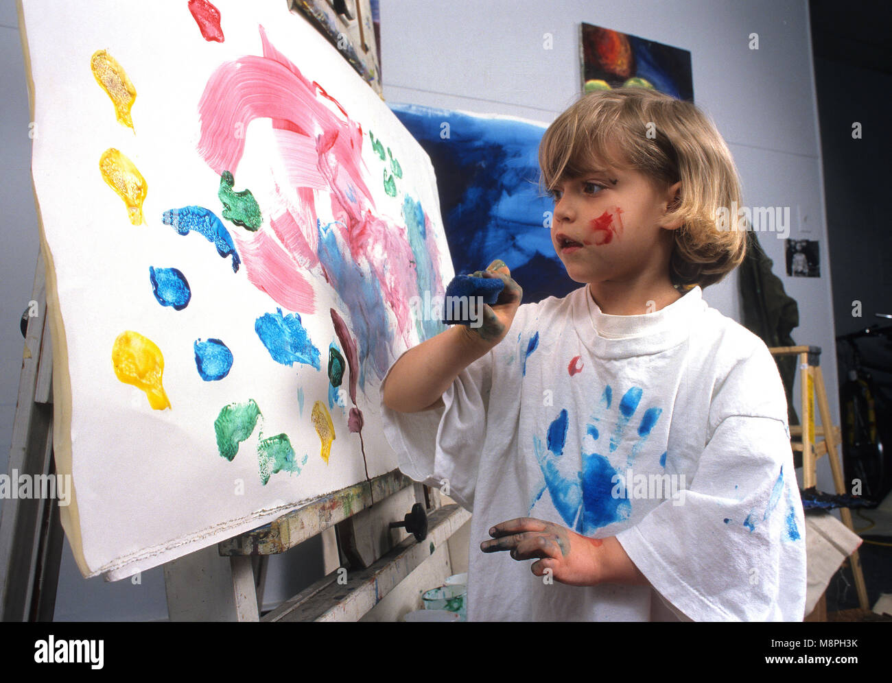 A young girl spongepainting Stock Photo