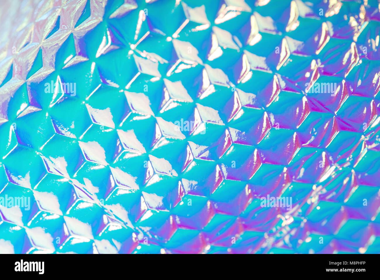 Holographic ultra violet foil creative background with geometric pattern. Stock Photo