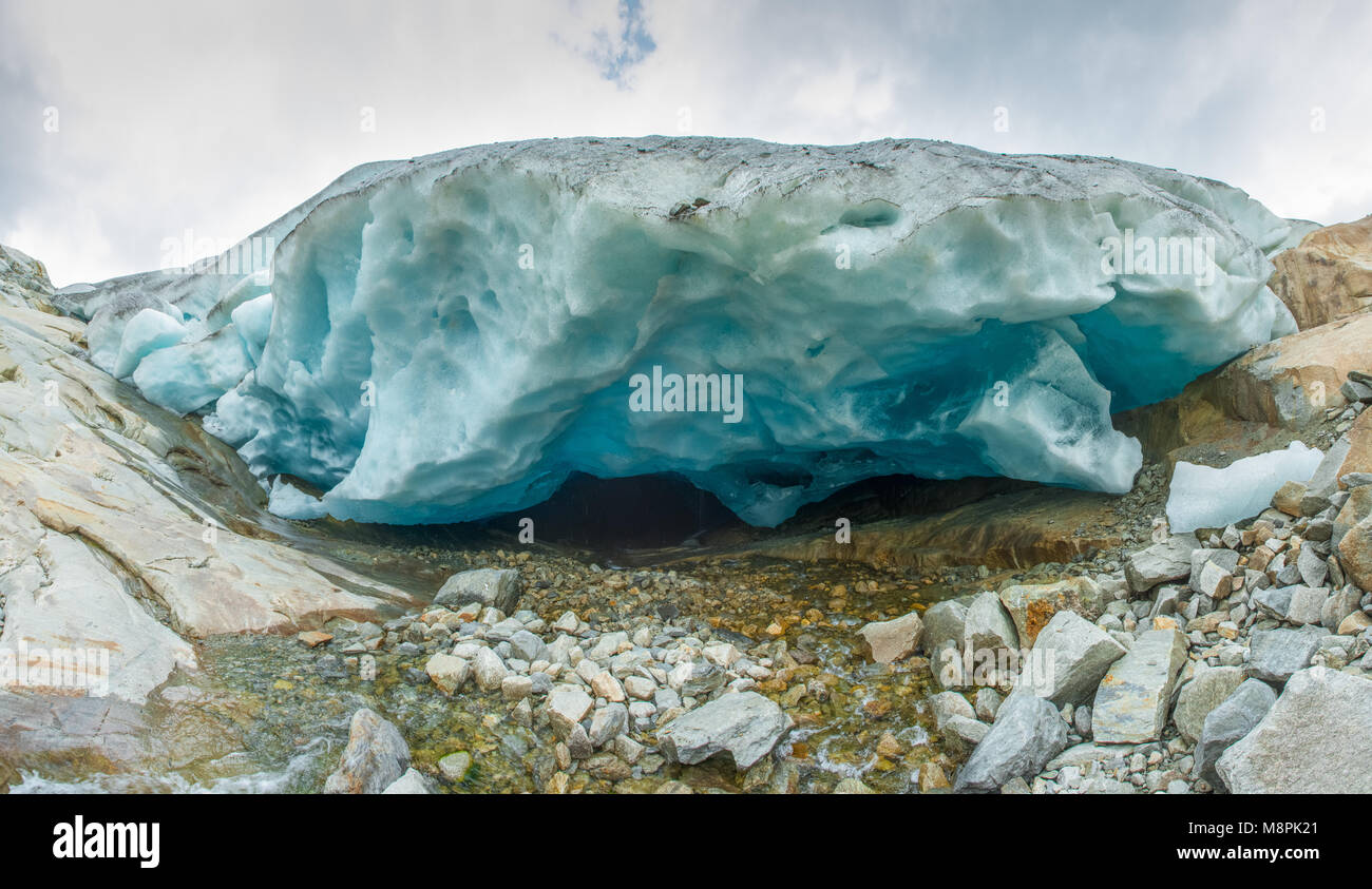 Deep blue ice at the bottom of Aletsch glacier, longest glacier in Europe. Cave, stream, icefield, melting ice, exploring the shrinking sheet. Stock Photo