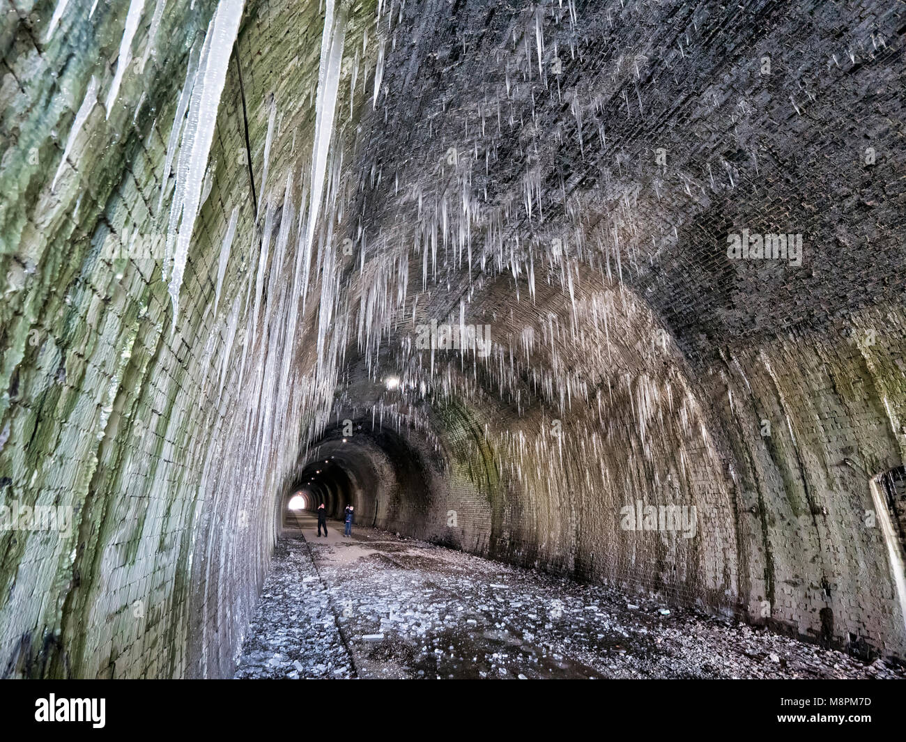 Tissington Trail railway walk, Peak District National Park, UK. 19th March, 2018. UK Weather: thawing icicles up to 6ft long pose a danger to walkers when they fall inside the frozen Ashbourne Tunnel on the Tissington Trail railway walk in the Peak District National Park, Derbyshire, England, UK Credit: Doug Blane/Alamy Live News Stock Photo