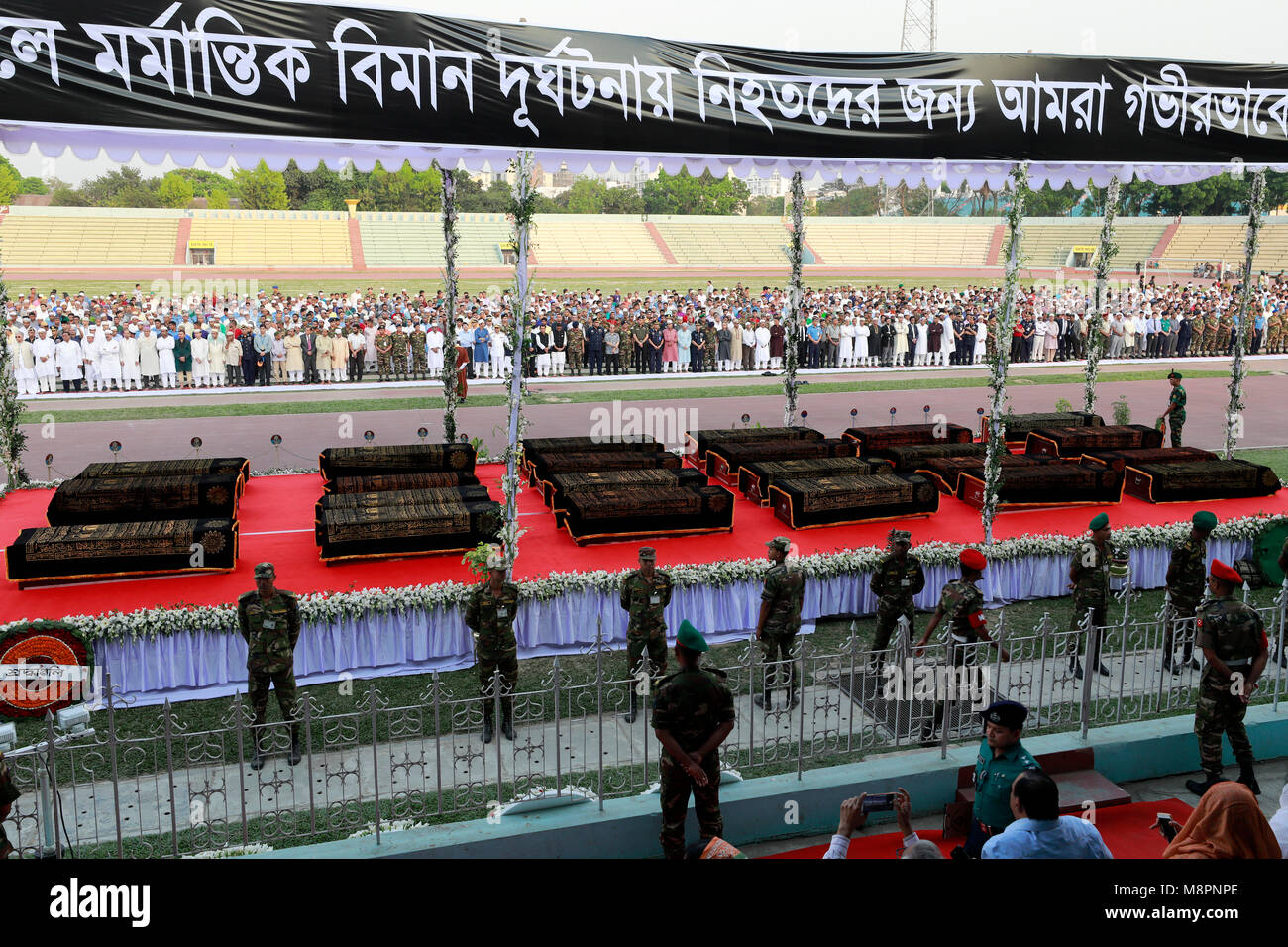 Dhaka, Bangladesh. 19th March, 2018.  Bodies of the 23 Bangladeshi crash victims lined up at the Army Stadium in Dhaka for namaz-e-janaza on March 19, 2018. Credit: SK Hasan Ali/Alamy Live News Stock Photo