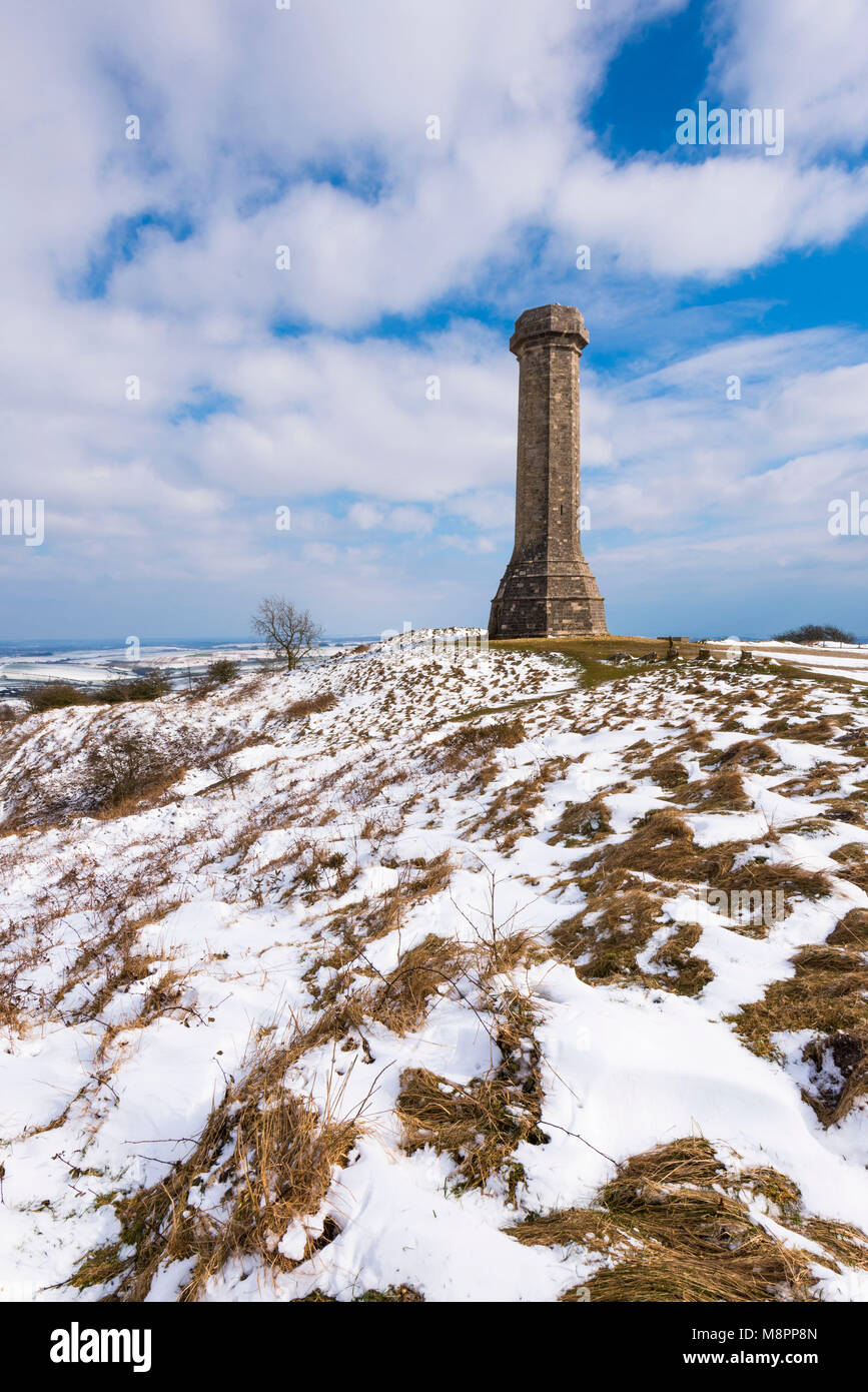Hardy's Monument, Portesham, Dorset, UK.  19th March 2018.  UK Weather.  Snow at Hardy's Monument on Black Down near Portesham in Dorset on an afternoon of sunny spell but cold winds.  The monument was built in memory of Vice Admiral Sir Thomas Masterman Hardy who was captain of HMS Victory in the Battle of Trafalgar under Admiral Nelson.  Picture Credit: Graham Hunt/Alamy Live News. Stock Photo