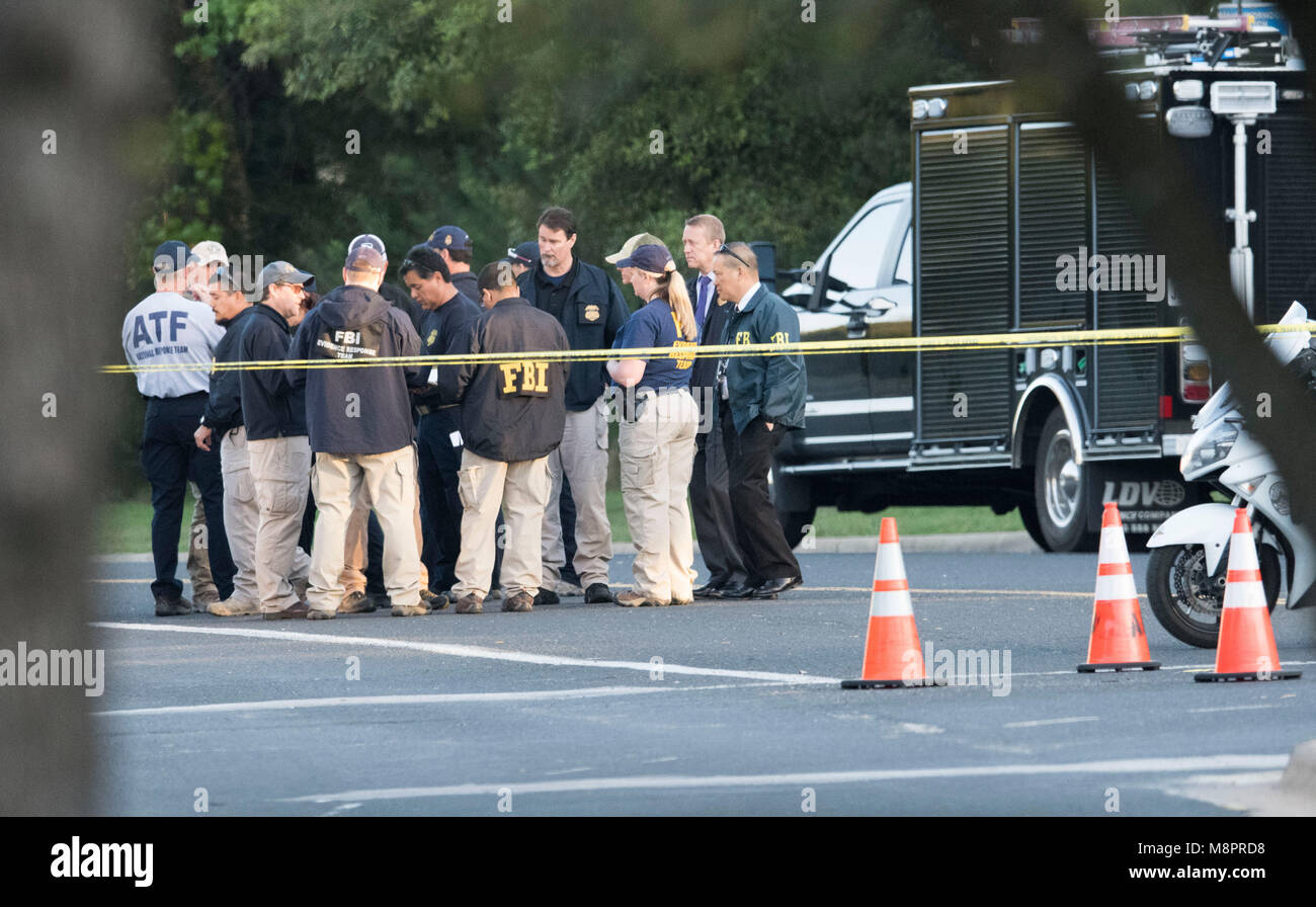 Federal and local law enforcement agencies, including the Austin police, ATF and FBI, investigate at the scene of a package bomb explosion, the 4th in 3 weeks in Austin, that exploded Sunday night on a southwest Austin roadside injuring two men. Police say a possible 'trip wire' was used to detonate the device. Stock Photo