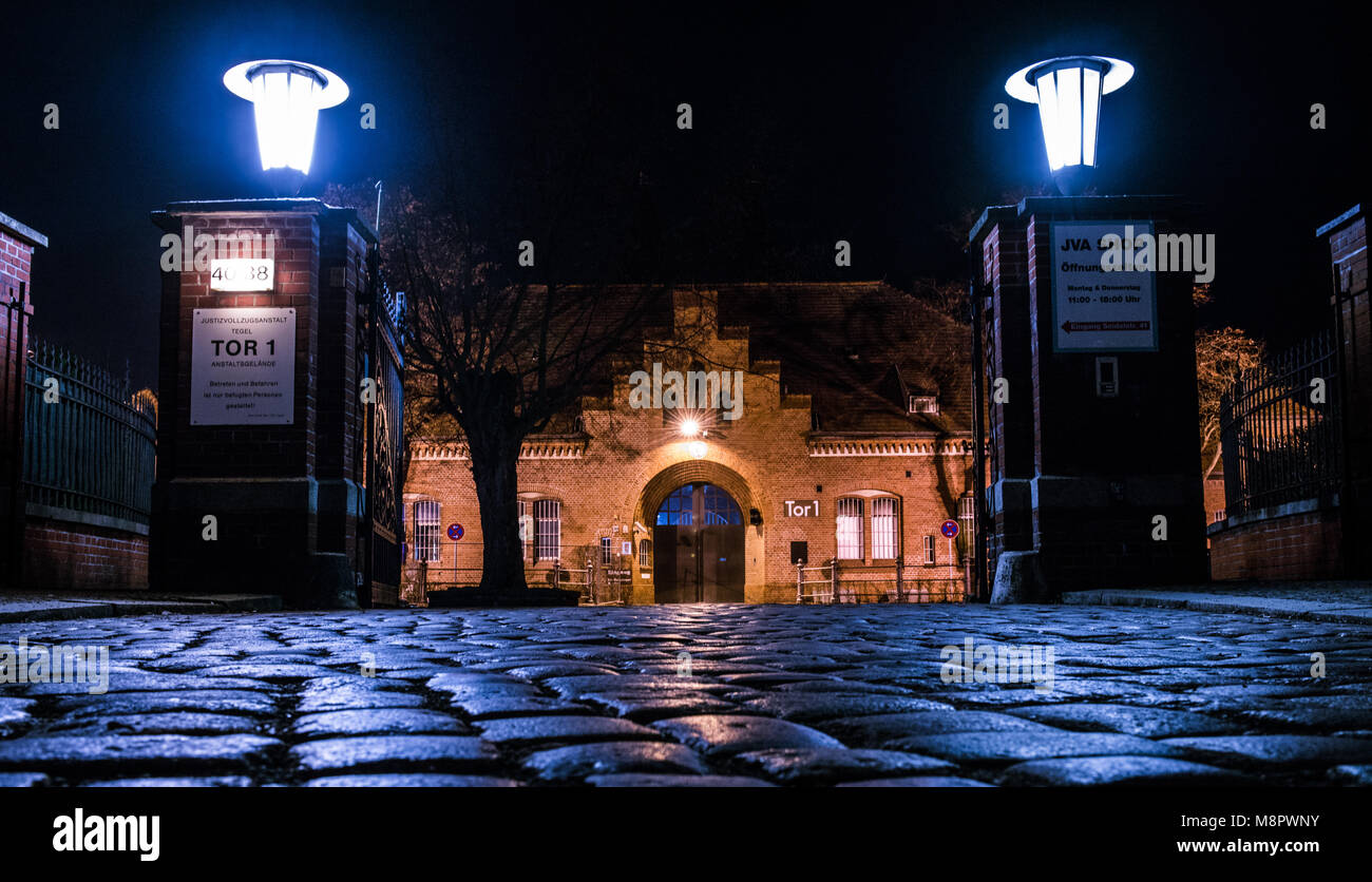15 March 2018, Germany, Berlin: The main entrance of Tegel prison is illuminated in the evening. (taken with long time exposure) Photo: Paul Zinken/dpa Stock Photo