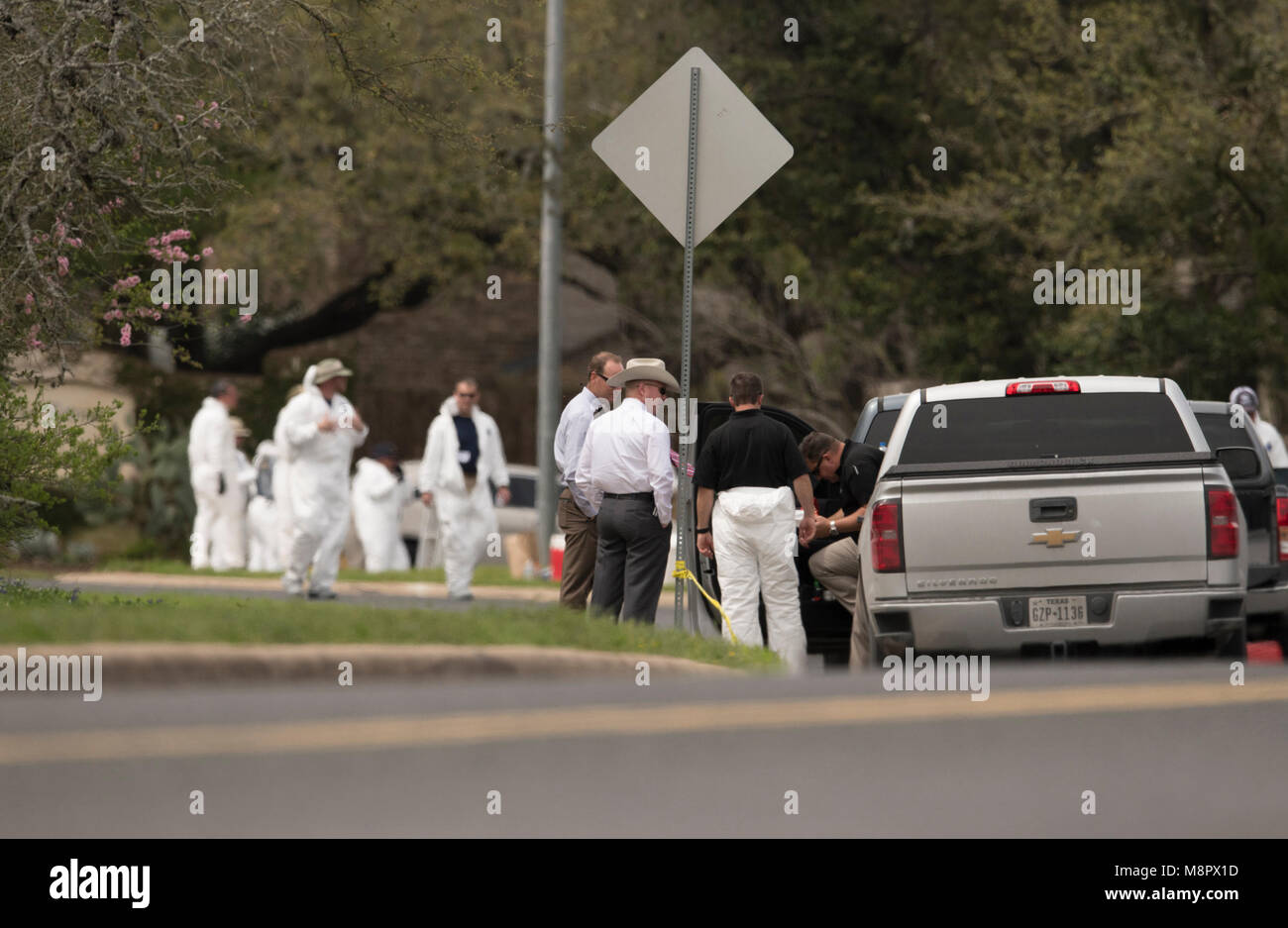 Law enforcement officials work into the afternoon as a fourth package bomb  exploded on a southwest Austin roadside injuring two men. Stock Photo