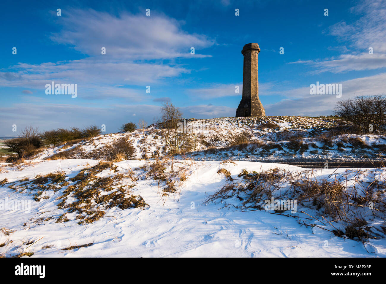 Hardy's Monument, Portesham, Dorset, UK.  19th March 2018.  UK Weather.  Snow at Hardy's Monument on Black Down near Portesham in Dorset on an afternoon of sunny spells but cold winds.  The monument was built in memory of Vice Admiral Sir Thomas Masterman Hardy who was captain of HMS Victory in the Battle of Trafalgar under Admiral Nelson.  Picture Credit: Graham Hunt/Alamy Live News. Stock Photo