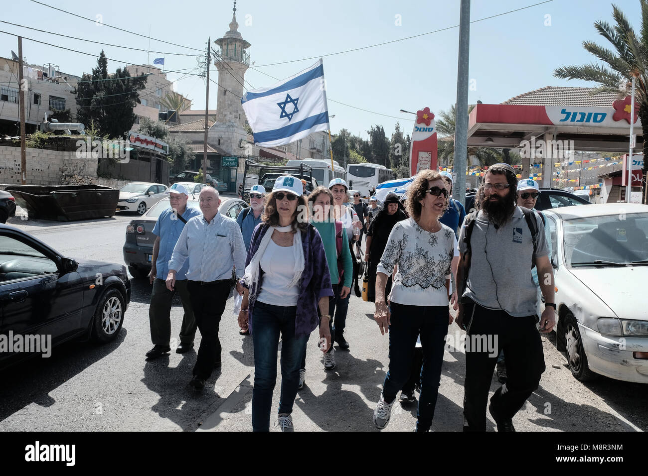 Jerusalem, Israel. 20th March, 2018. Jewish activists march past the Sheikh Jarrah Mosque as they follow in the path of the April 13th, 1948 convoy of doctors, nurses and medical supplies to besieged Hadassah Hospital on Mount Scopus, marking 70 years (Hebrew calendar) to the Arab convoy ambush and massacre of 78 people in the Arab neighborhood of Sheikh Jarrah. Credit: Nir Alon/Alamy Live News Stock Photo