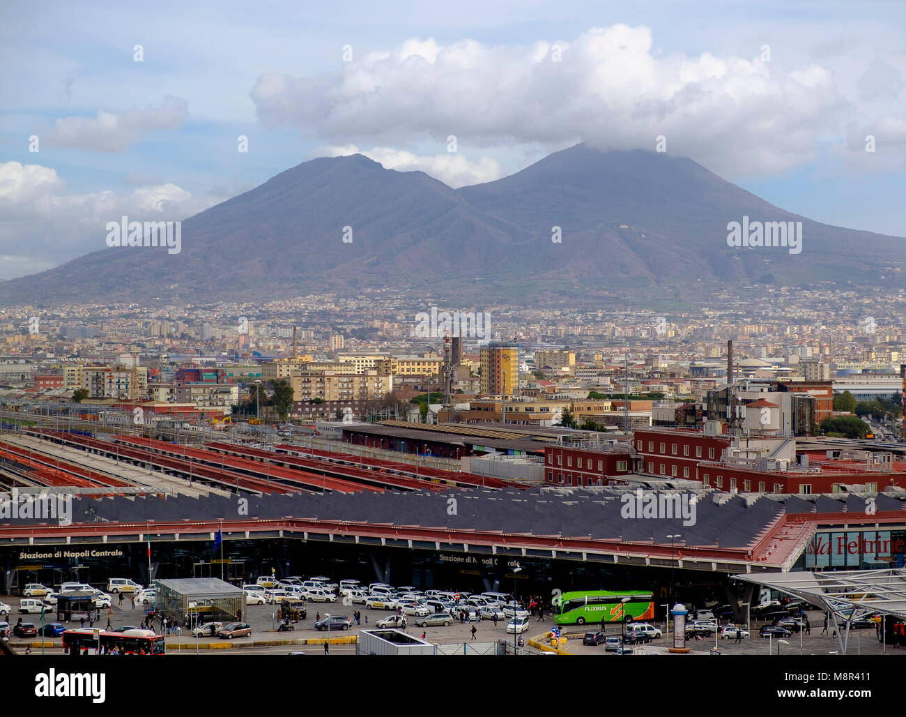 In the foreground Stazione di Napoli Centrale with the looming volcano