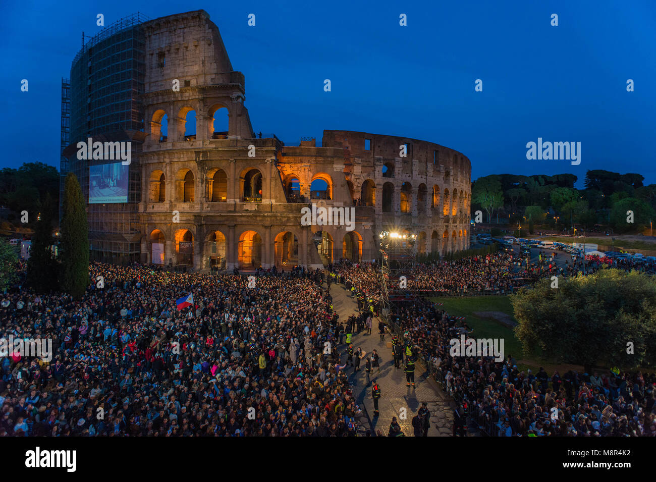 Rome. People gather in front of the Roman Ancient Colisseum during the celebration of Pope Francis Way of the Cross, part of the solemn celebrations o Stock Photo