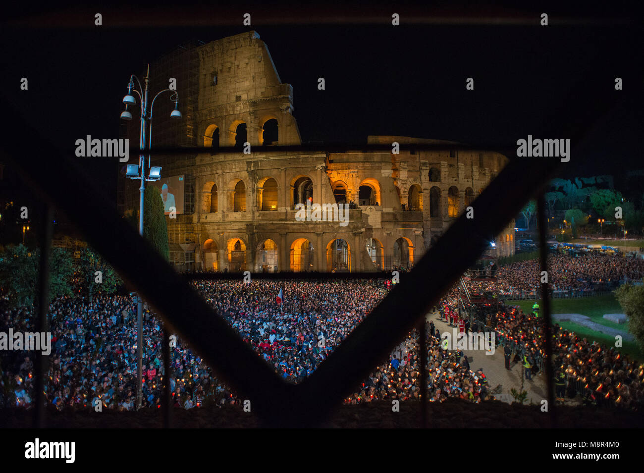 Rome. People gather in front of the Roman Ancient Colisseum during the celebration of Pope Francis Way of the Cross, part of the solemn celebrations o Stock Photo