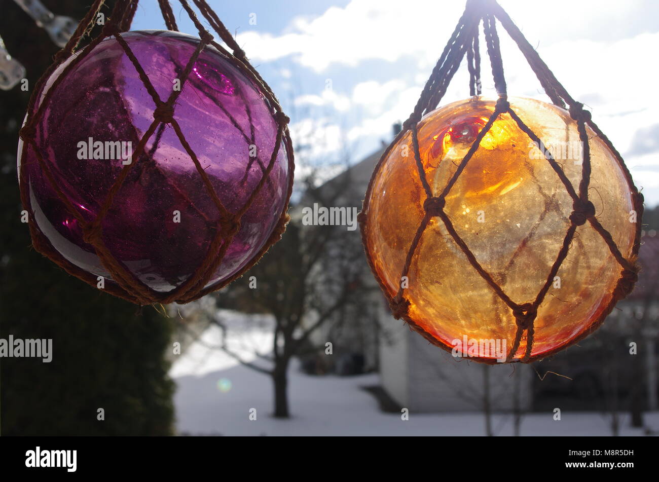 Balls Made of Glass Hanging in Rope Knots Stock Photo - Alamy