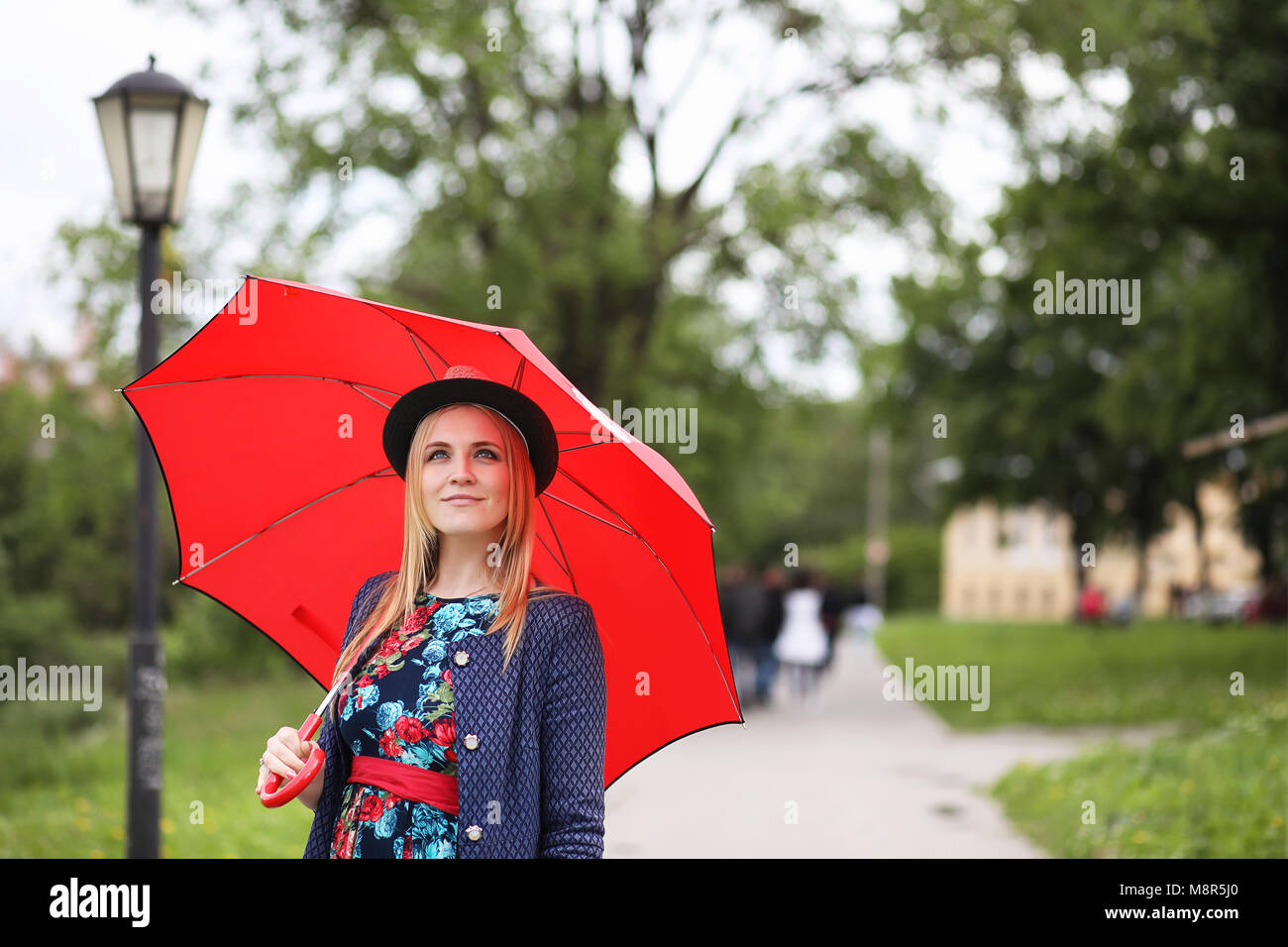 Girl in the street with an umbrella Stock Photo - Alamy