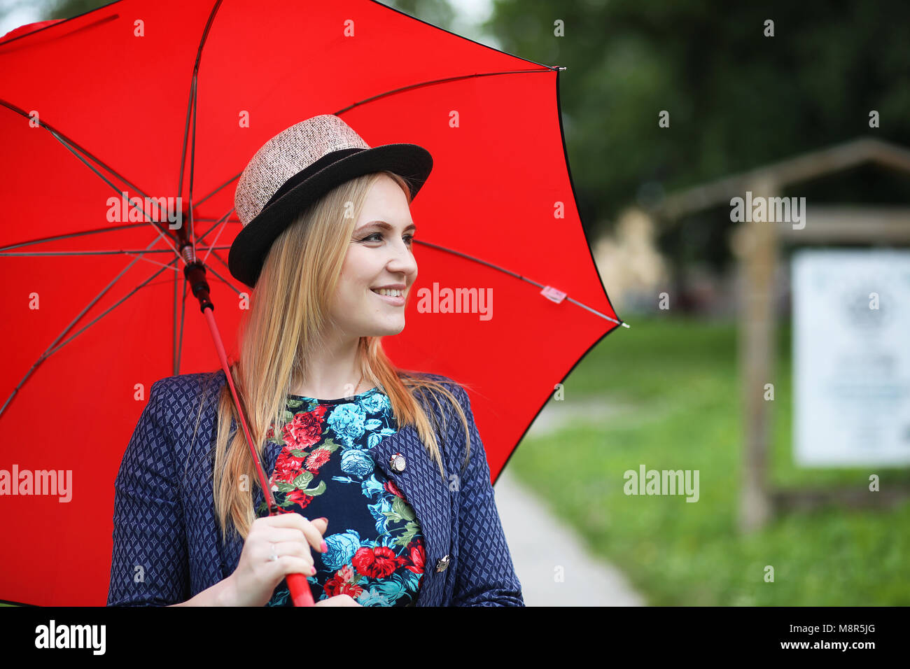 Girl in the street with an umbrella Stock Photo - Alamy