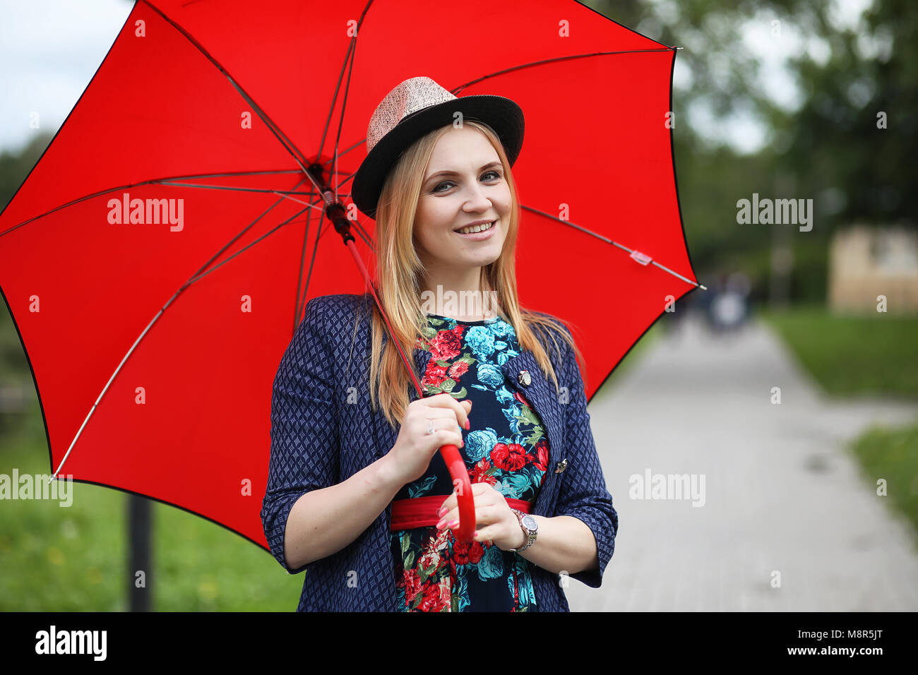 Girl in the street with an umbrella Stock Photo - Alamy