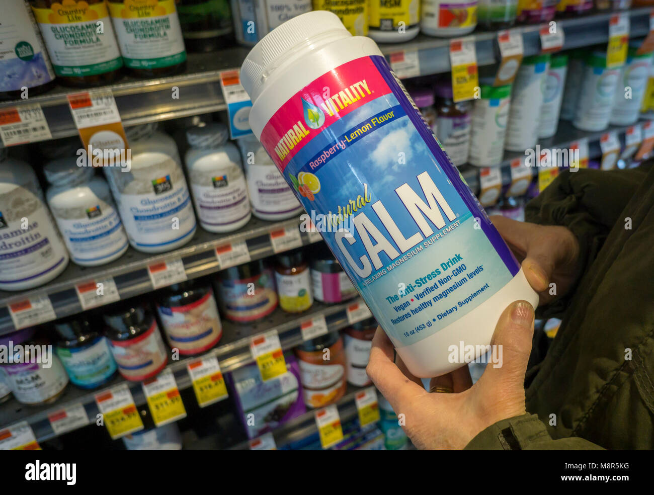 A consumer chooses a jar of Natural Vitality brand Natural Calm supplement in a store in New York on Monday, March 12, 2018. The Clorox Co. is buying Nutranext, the maker of the supplements, for $700 million expanding its dietary supplements business.(Â© Richard B. Levine) Stock Photo