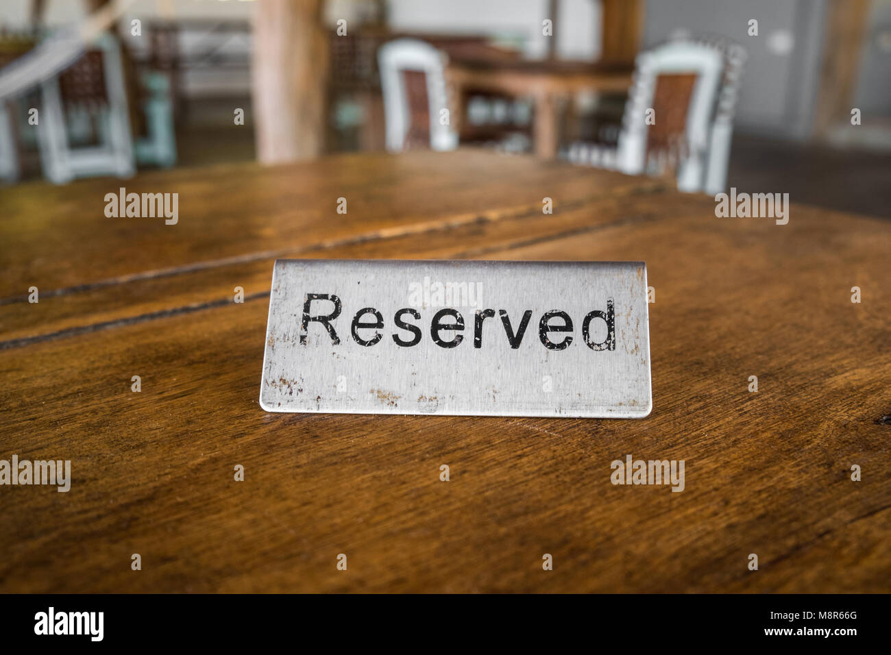 reserved sign on table in restaurant closeup - vintage style Stock Photo