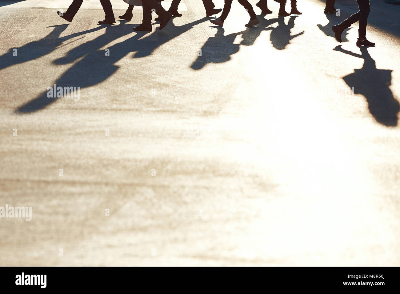 People walking on the street with sunset background Stock Photo - Alamy
