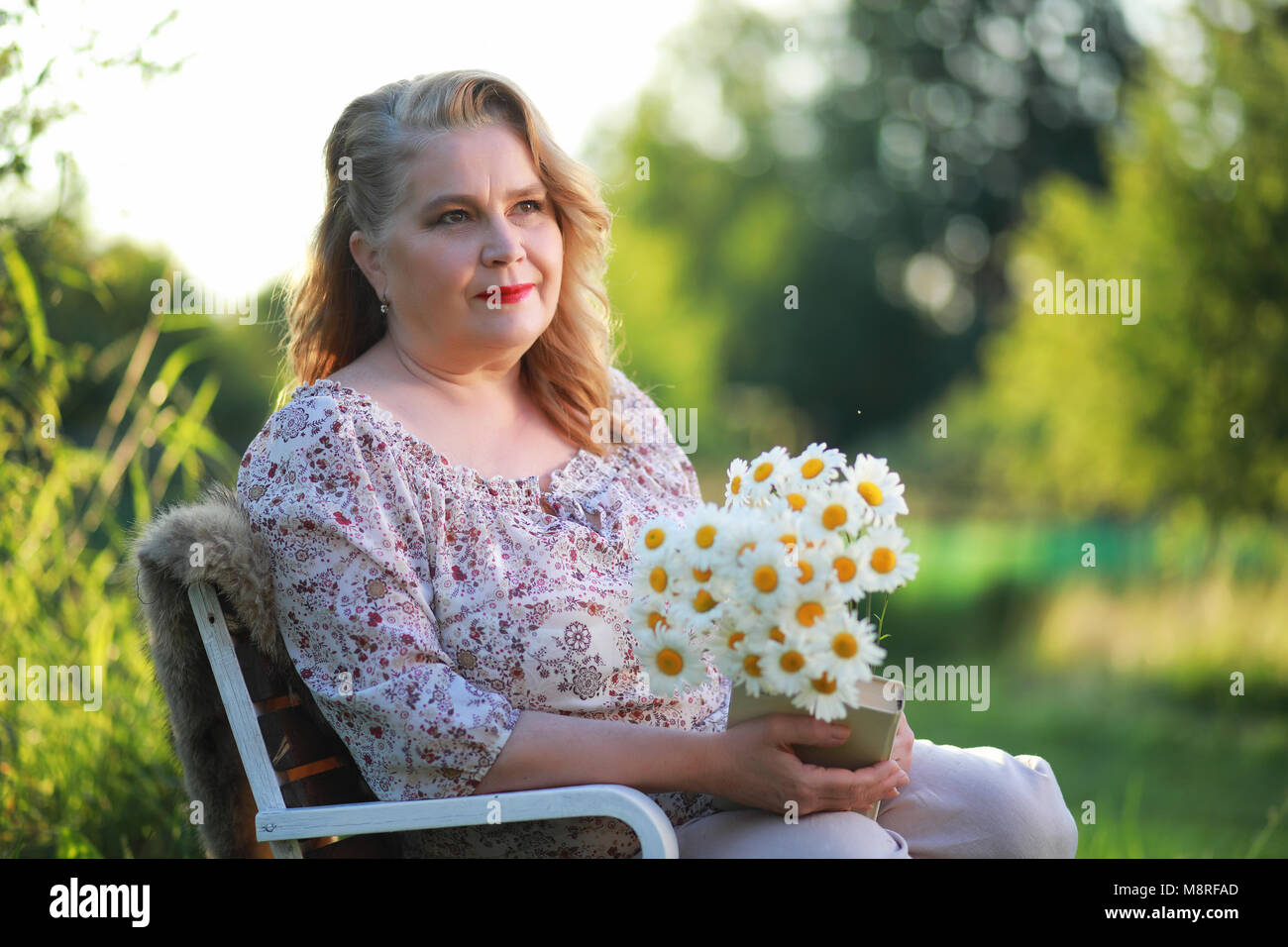 An elderly woman on the porch of a house Stock Photo - Alamy