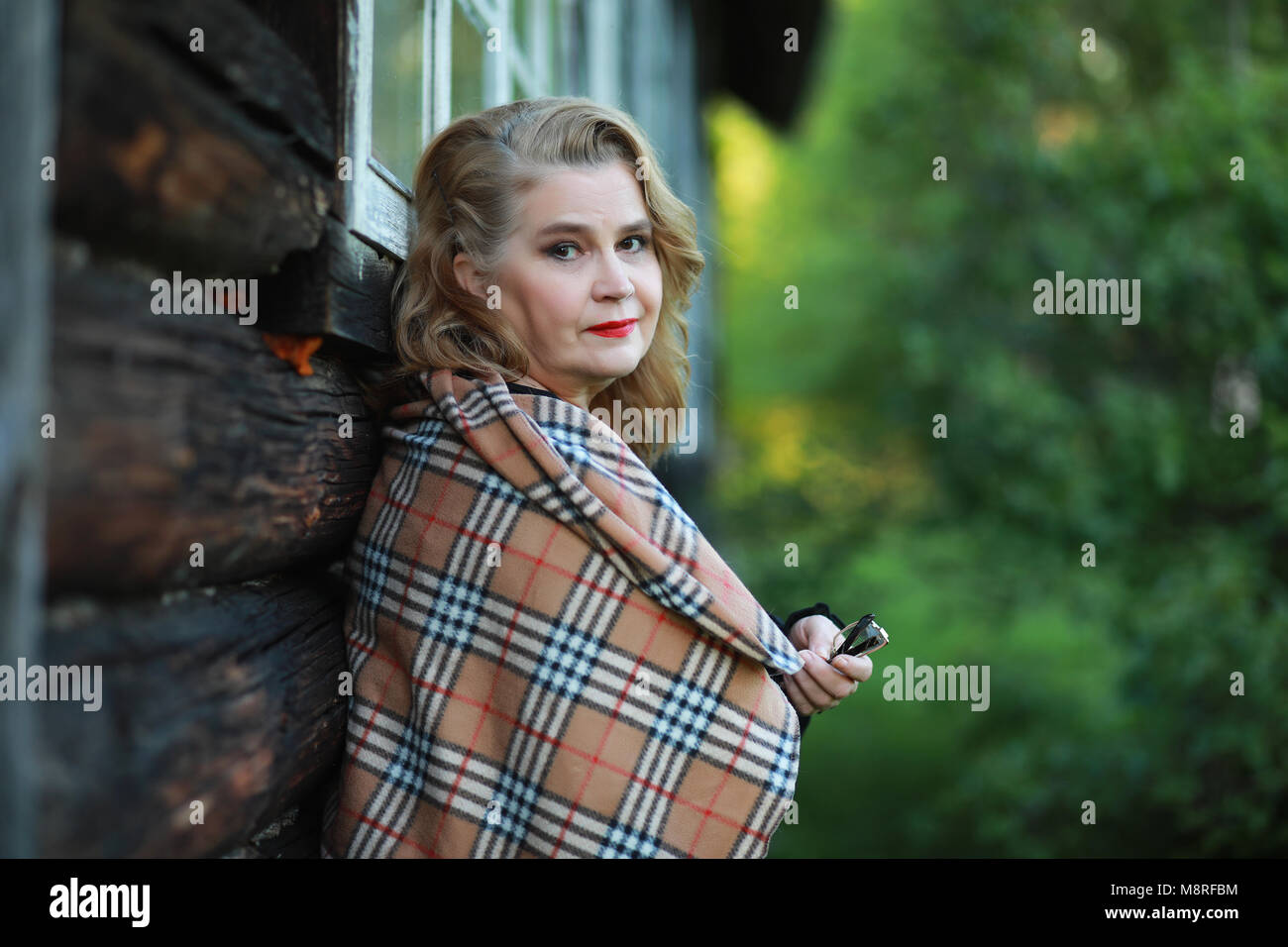 An elderly woman on the porch of a house Stock Photo - Alamy
