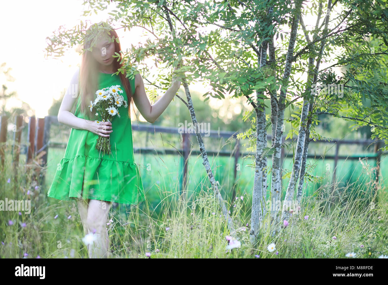 beautiful girl with red hair with a bouquet Stock Photo - Alamy