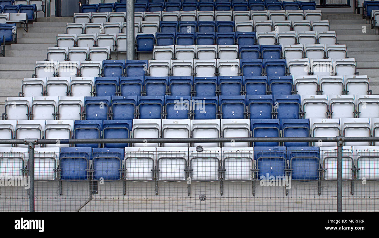 empty stadium seats making up the letter A in blue and white before a match in castletownshend, west cork, ireland. Stock Photo