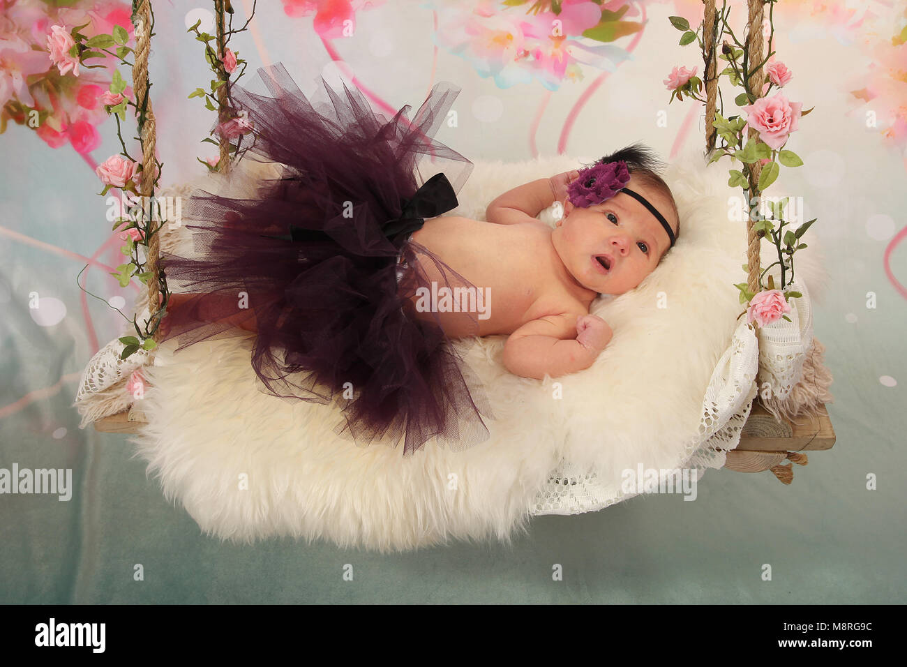 Cutie Newborn Baby Girl On Sensory Swing In Nursery