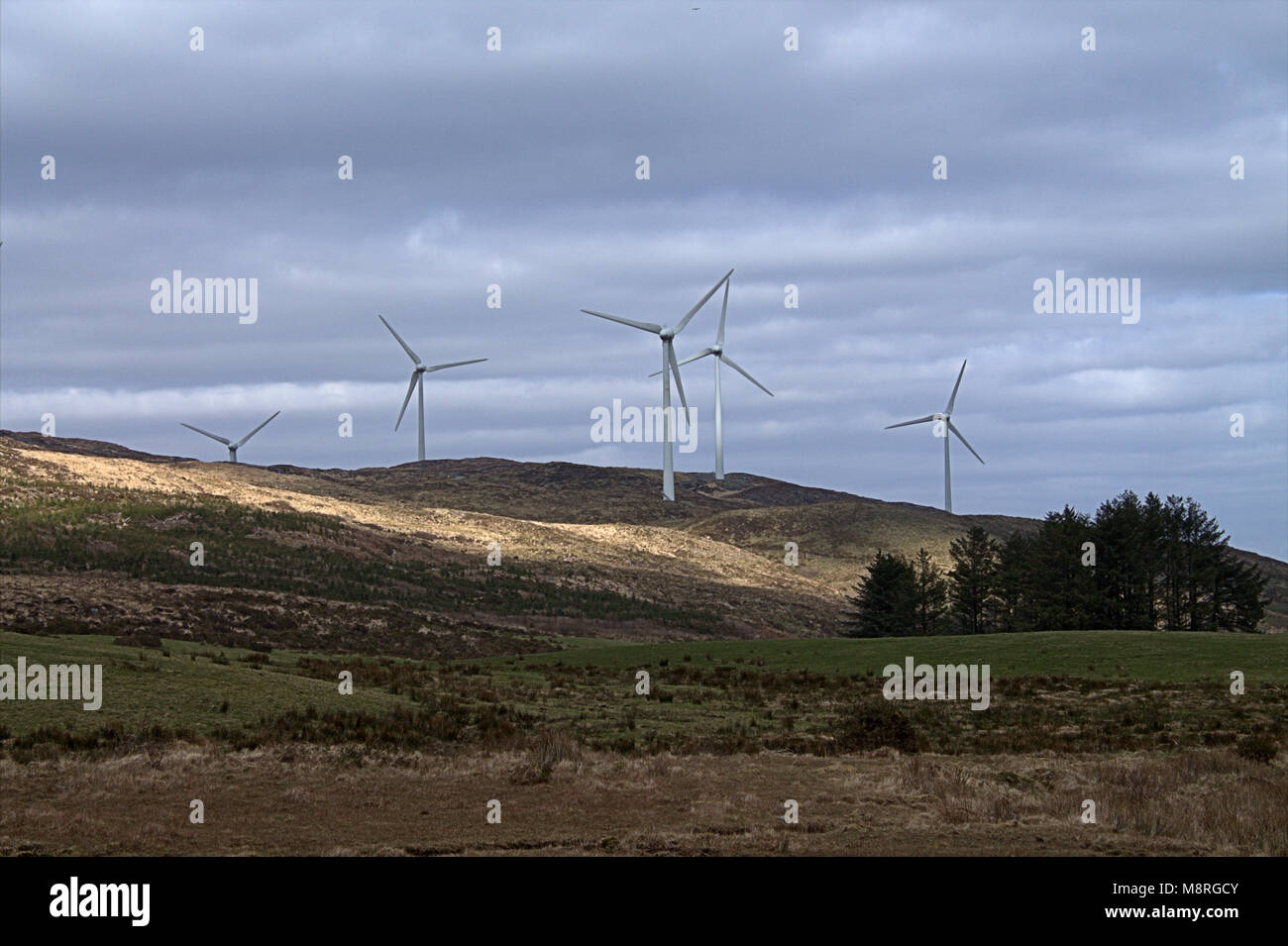 turbine blades spinning on a wind farm, windfarm on a hillside of west