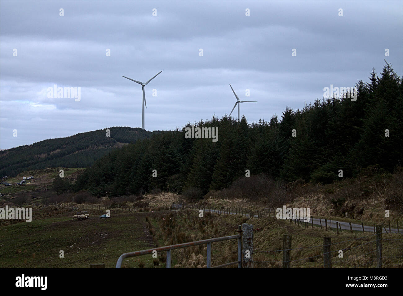turbine blades spinning on a wind farm, windfarm on a hillside of west