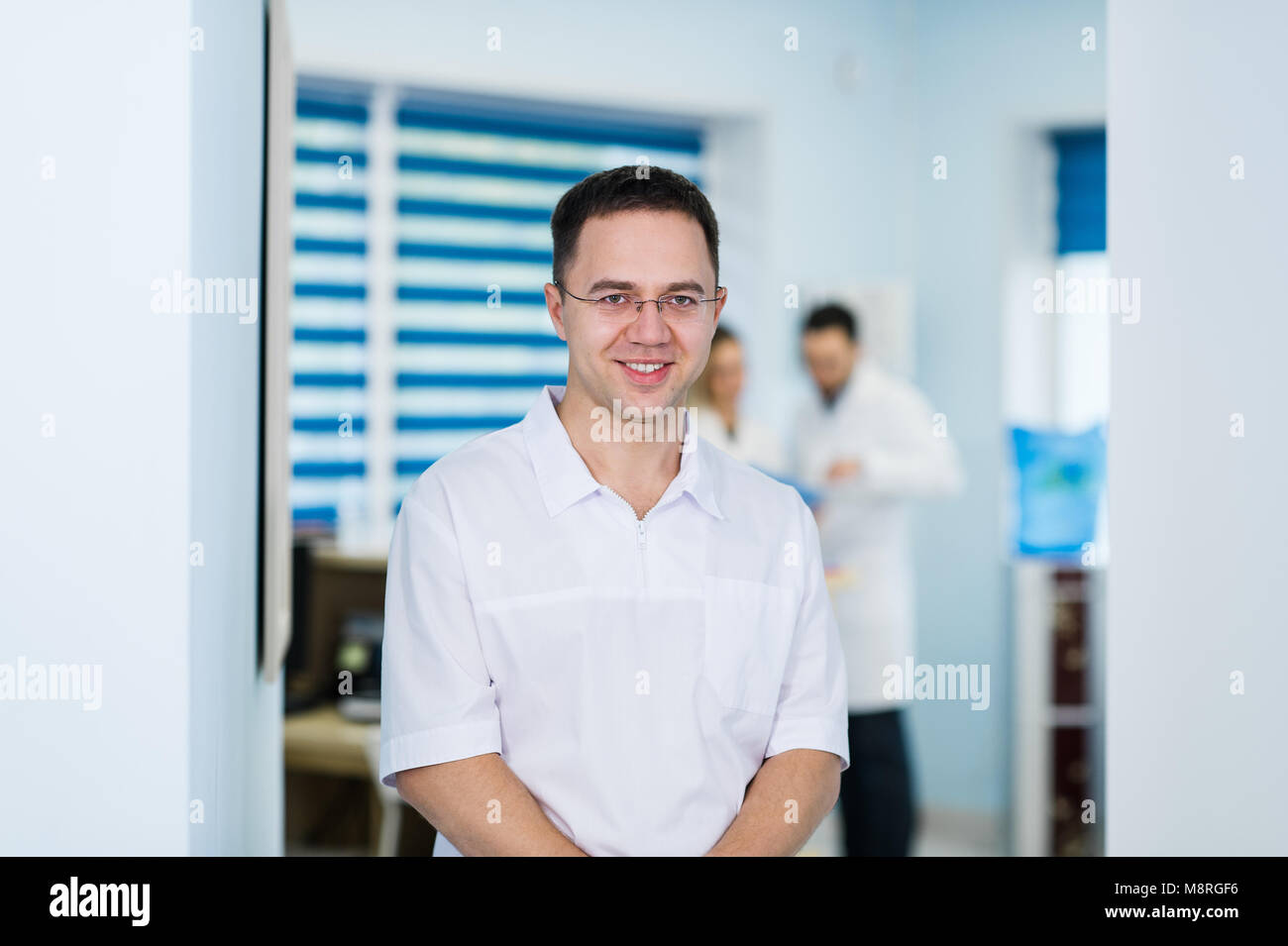 Portrait of friendly male doctor smiling Stock Photo - Alamy