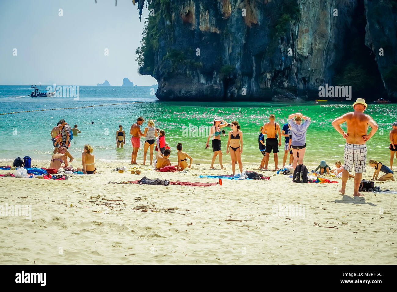PHRA NANG, THAILAND - FEBRUARY 09, 2018: Beautiful outdoor view of unidentified people enjoying the beautiful sunny day, white sand and turquoise water on Phra nang island Stock Photo