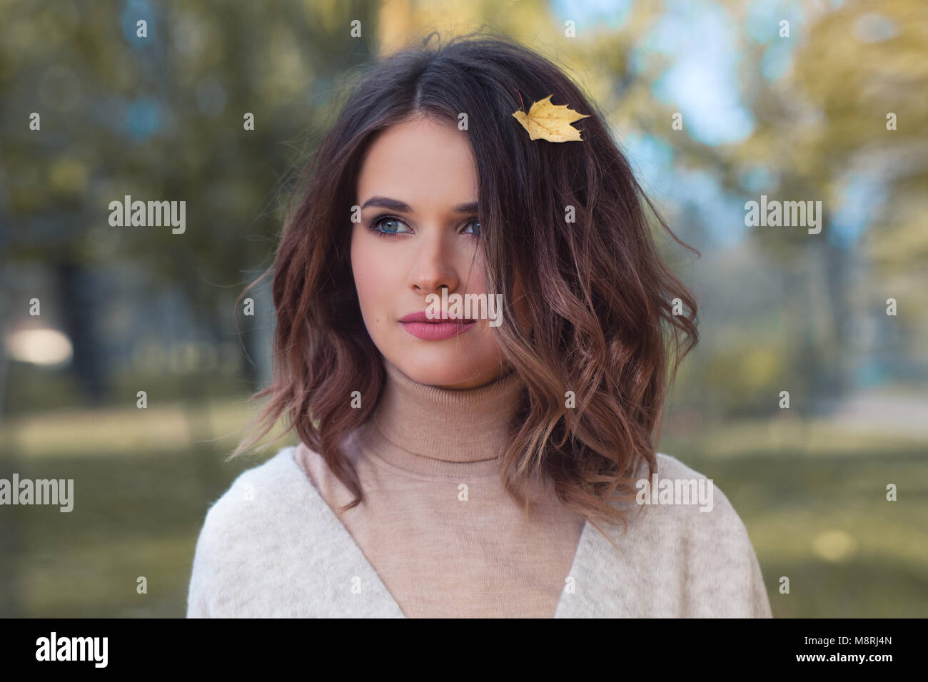 Perfect Woman with Yellow Autumn Leaf in Brown Hair Outdoors. Beautiful ...