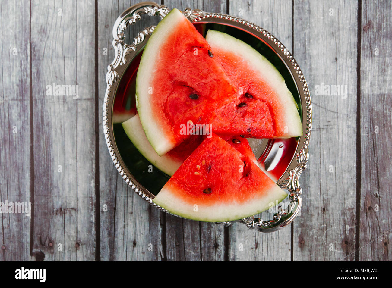 Overhead view of watermelon slices in bowl on wooden table Stock Photo
