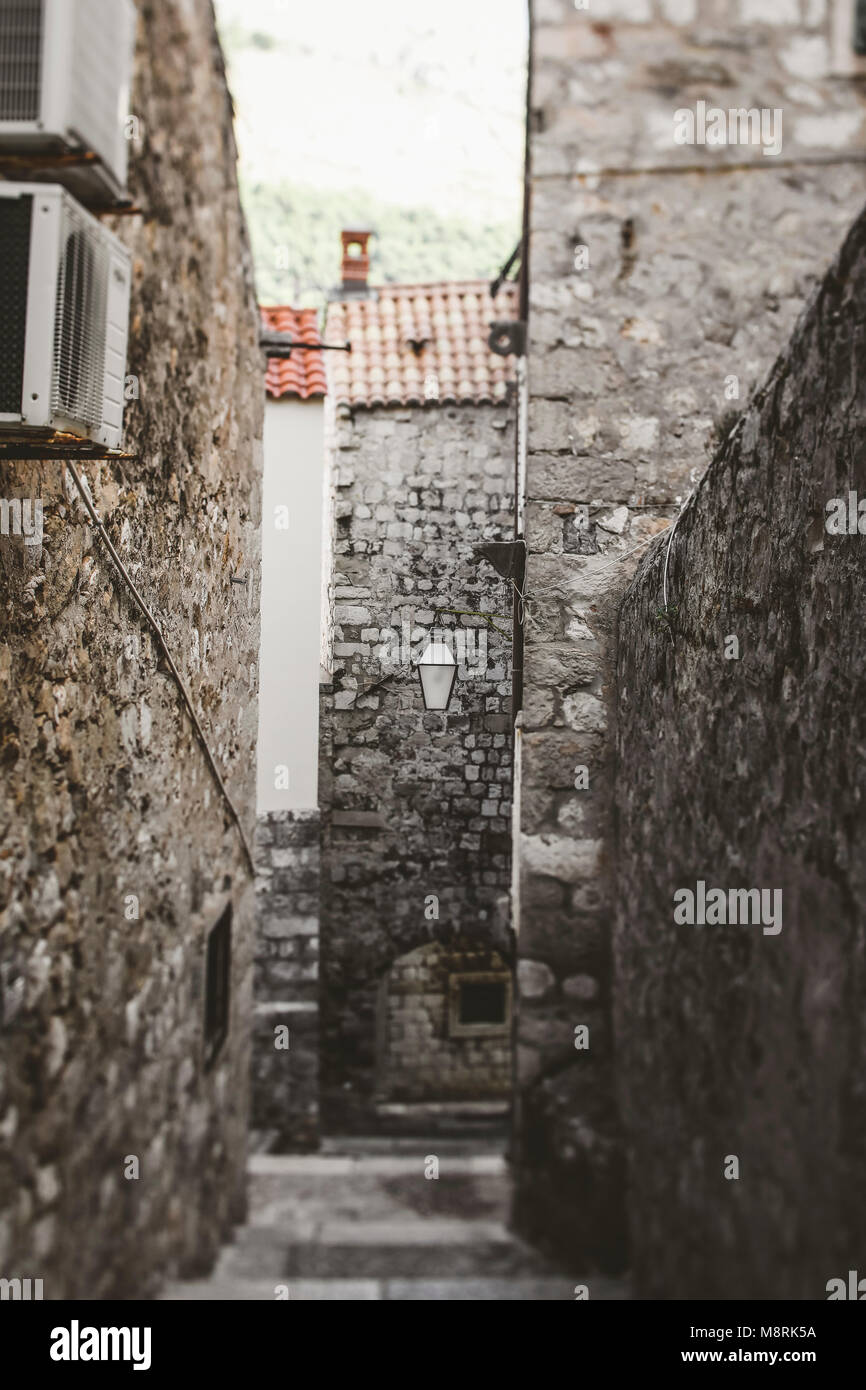 Empty alley amidst old buildings Stock Photo