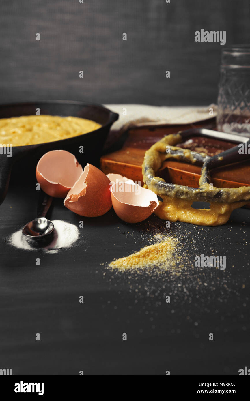 Close-up of messy kitchen counter with broken eggshells and kitchen utensils Stock Photo