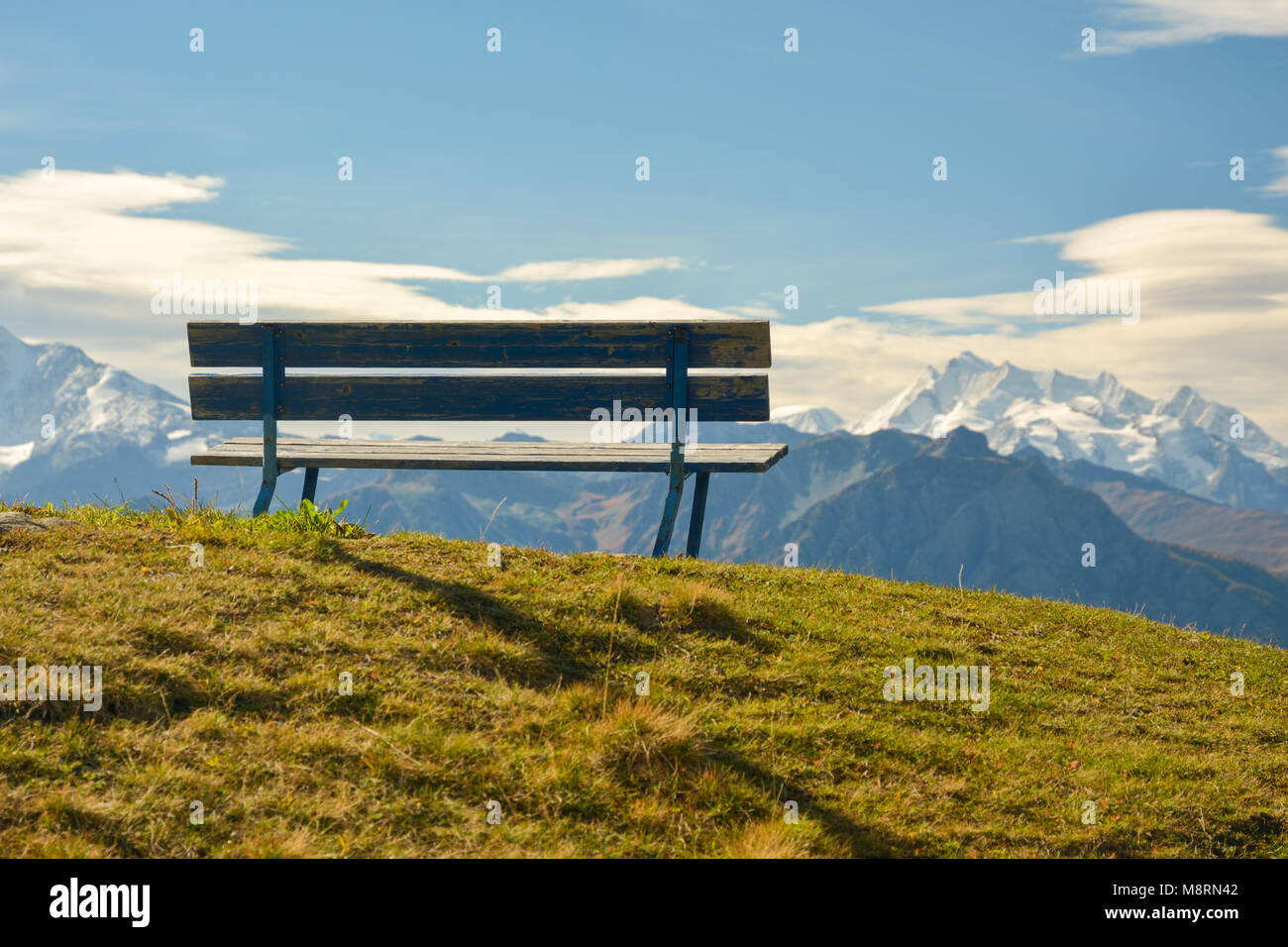 Bench in Bettmeralp in Switzerland with nice views on mountains Stock Photo