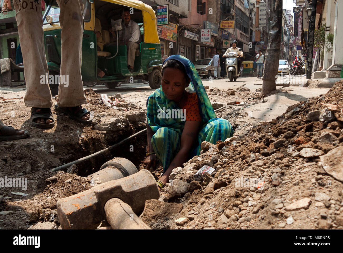 New Delhi, India: an Indian woman works on the renovation of sewers in the city of New Delhi Stock Photo