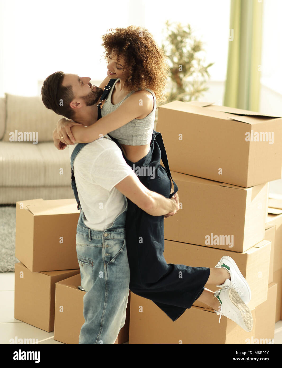 Portrait of a young couple moving into a new home Stock Photo - Alamy