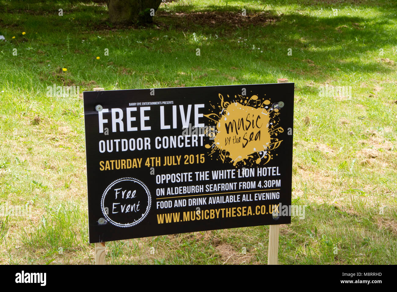 Board advertising free live outdoor concert Stock Photo