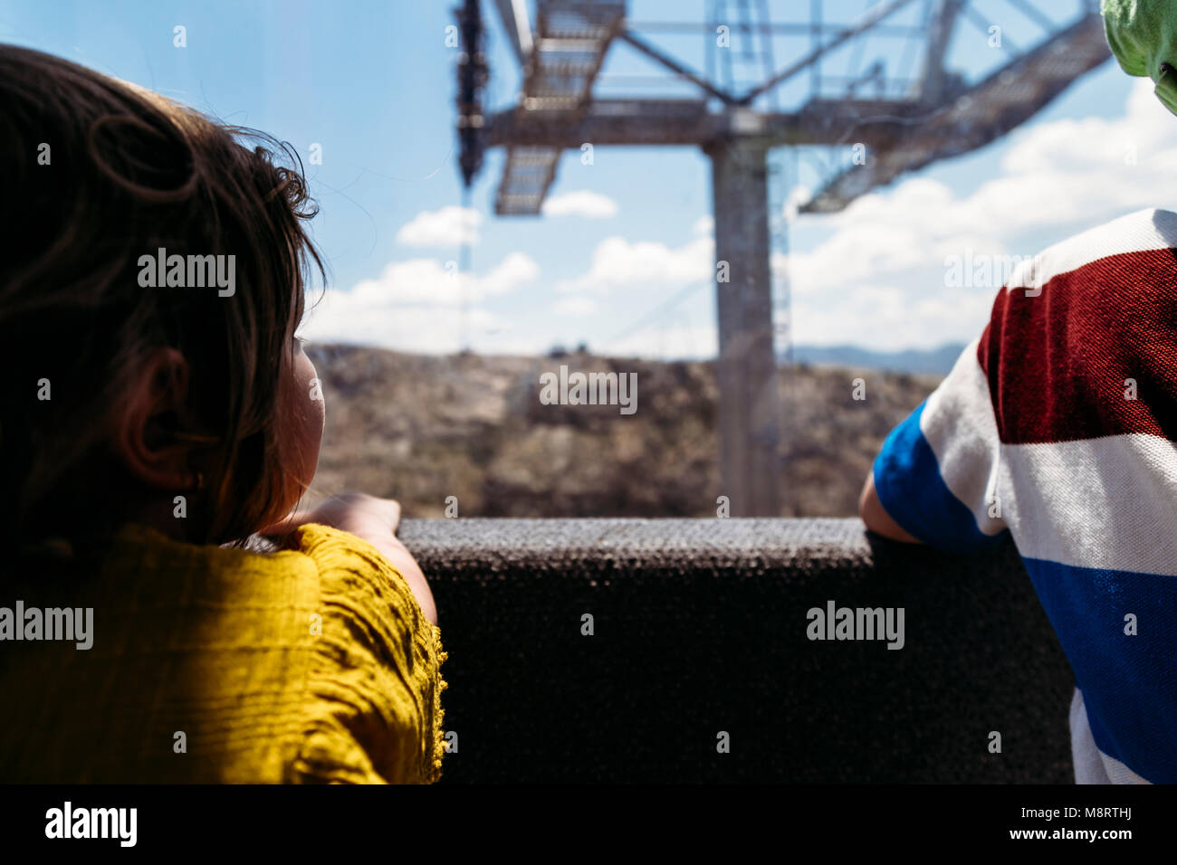 Rear view of siblings in overhead cable car Stock Photo