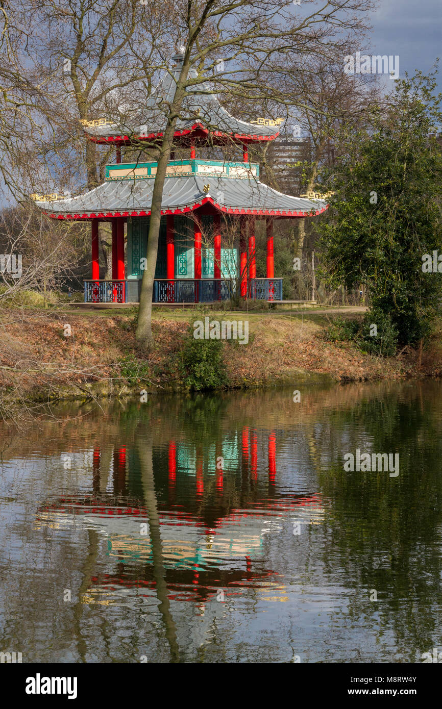The Chinese Pavilion in Victoria Park, London, seen on a spring day. The lake's still waters provide a lovely reflection Stock Photo