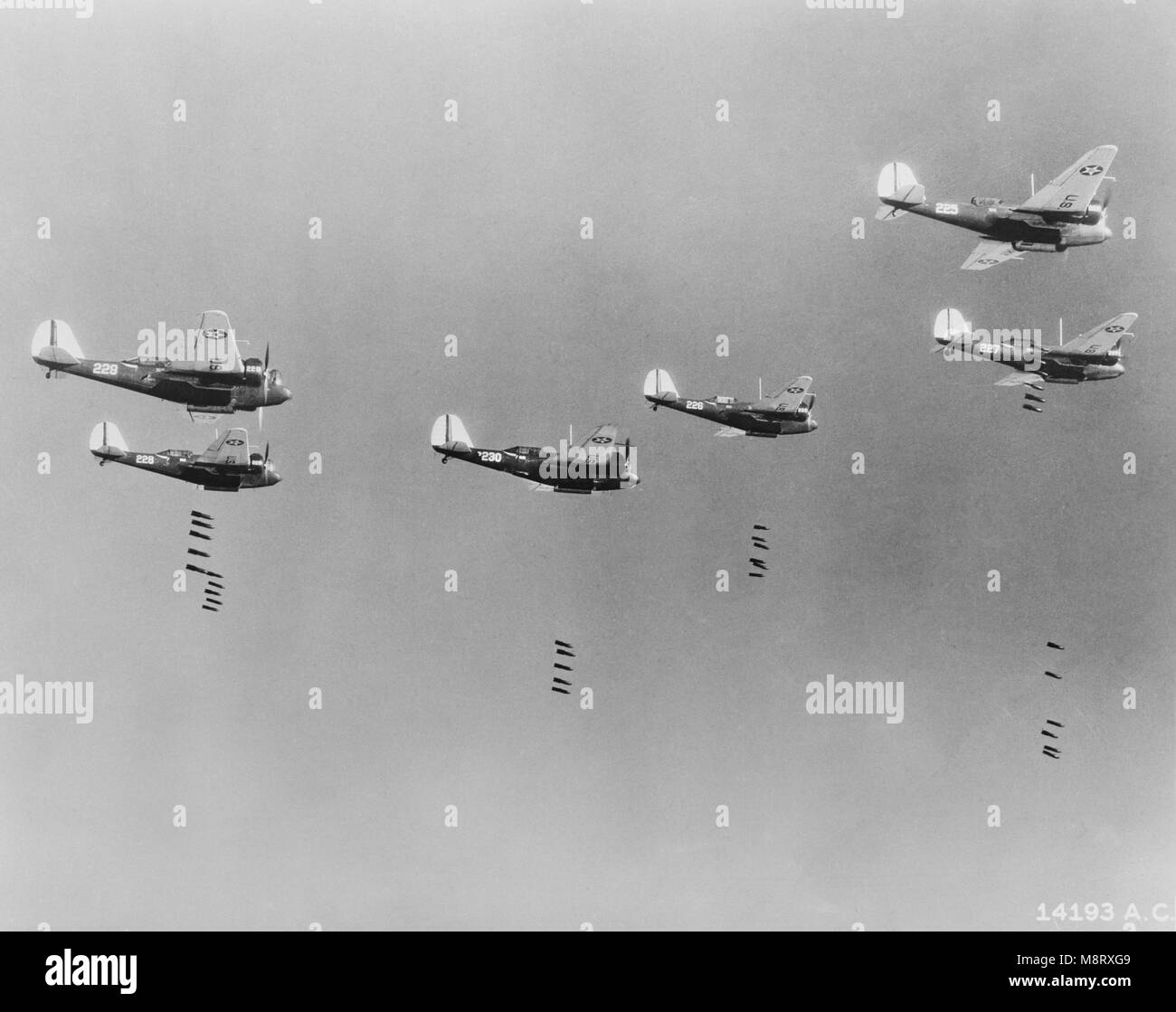 600-pound Bombs falling from Formation of B-10 Bombers in Bombing Practice by 19th Bombardment Group,  U.S. Army Air Corps, Office of War Information, early 1940's Stock Photo