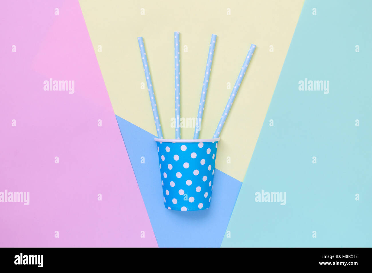 Paper party cup polka design with drinking straws on colorful pastel ...