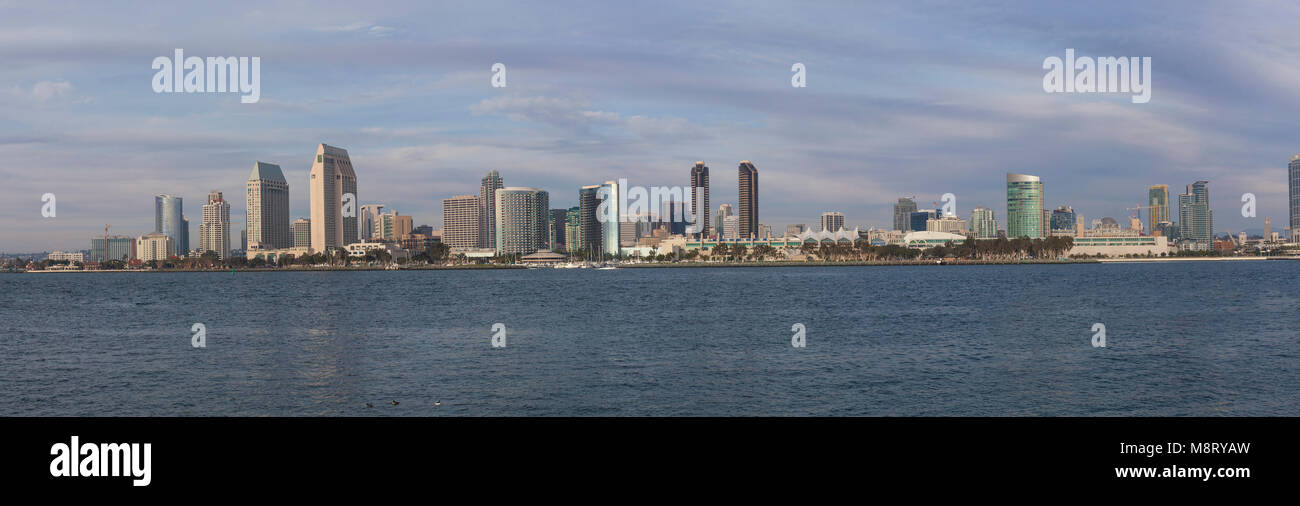 Panoramic view of modern buildings by river against cloudy sky Stock Photo