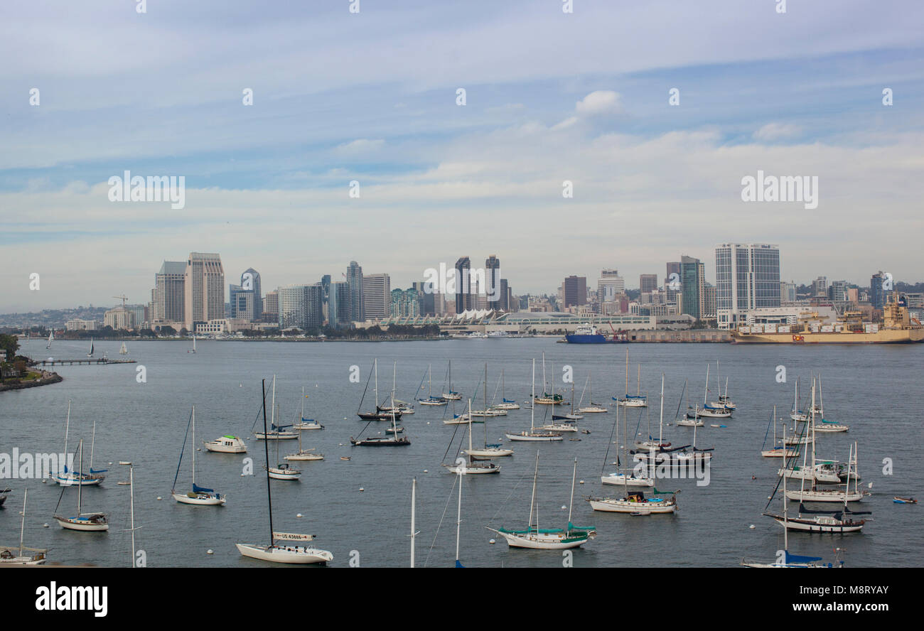 High angle view of boats moored at harbor by buildings against cloudy sky Stock Photo