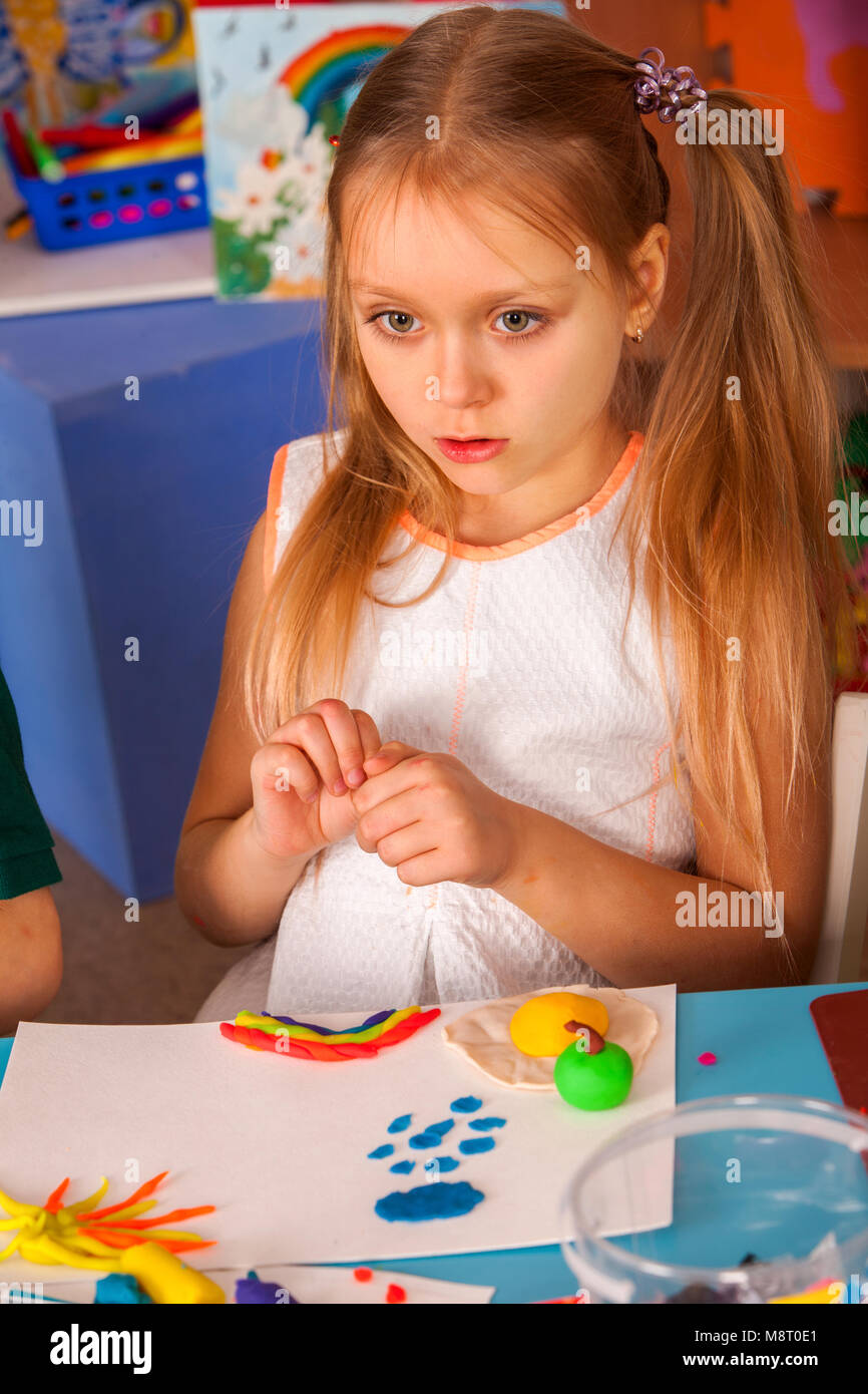 Plasticine modeling clay in children class. Teacher teaches in school